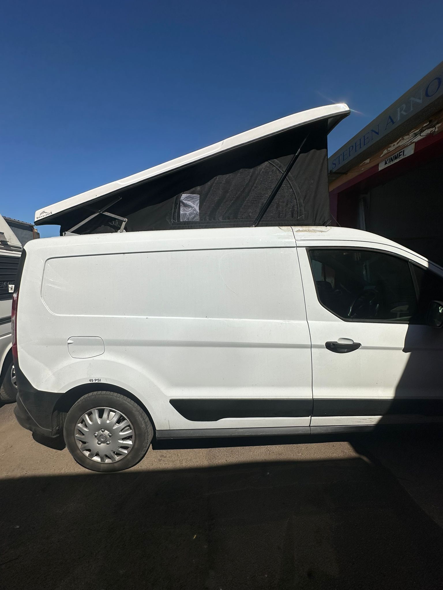 Ford Transit Connect pop top roof supplied and fitted by Pop Top Nation with black canvas and white roof shell