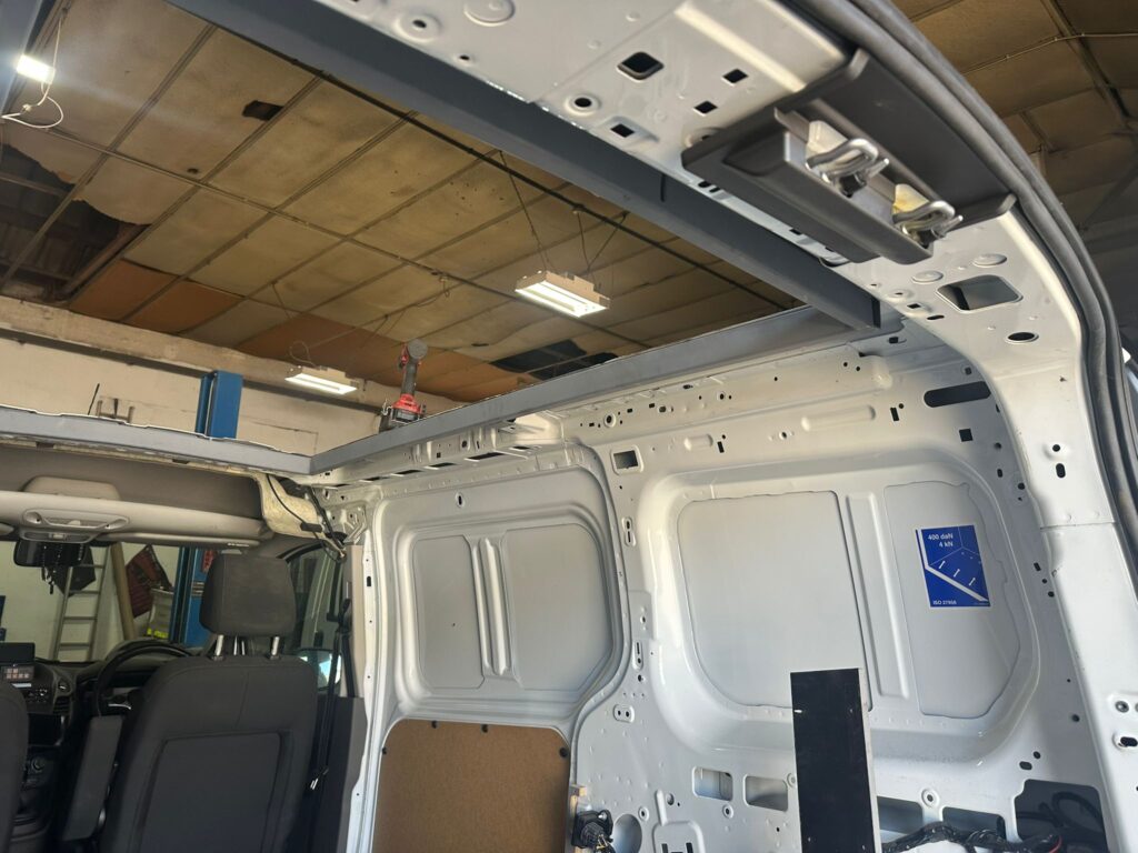 Ford Transit Connect interior prepared for pop top roof fitting with structural roof frame exposed